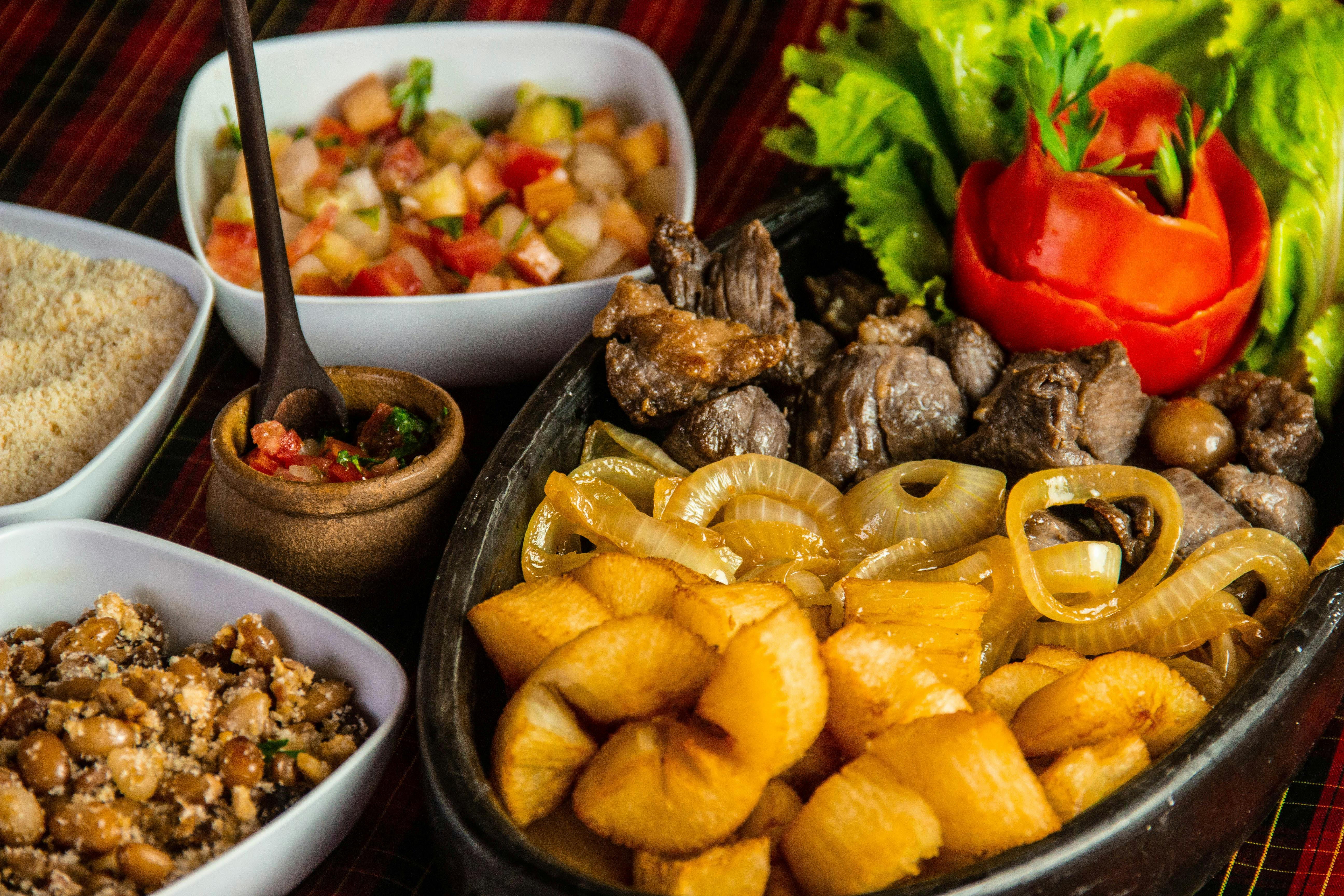 A sampling of Rio de Janeiro culinary delights displayed in serving dishes on a table